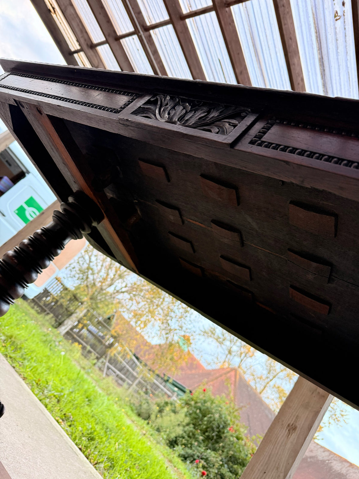 Underside of the rosewood library table showing the slatted support frame and carved frieze panel