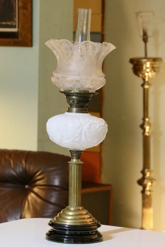 Victorian brass oil lamp with milk glass reservoir, three-quarter view