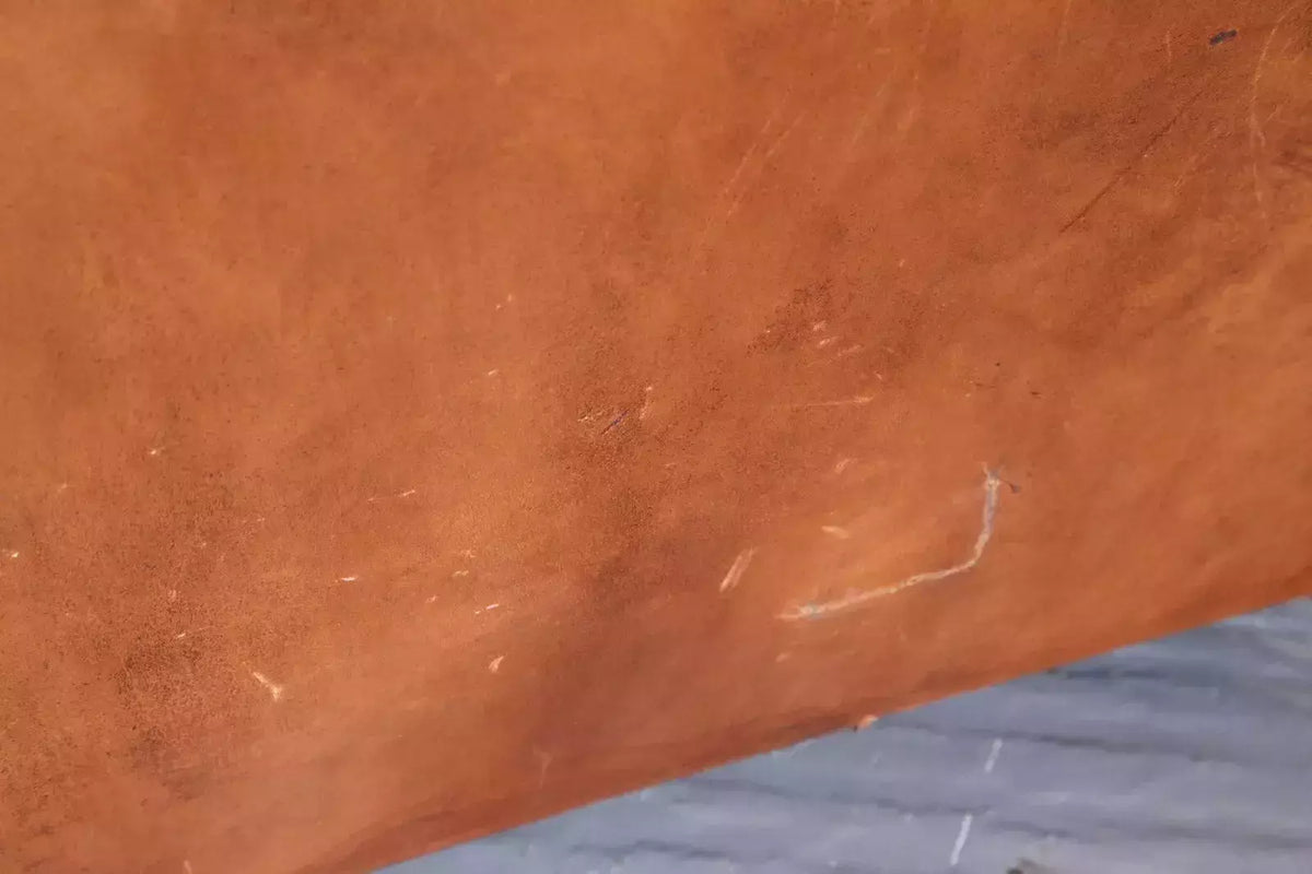 Close-up of patinated brown leather surface