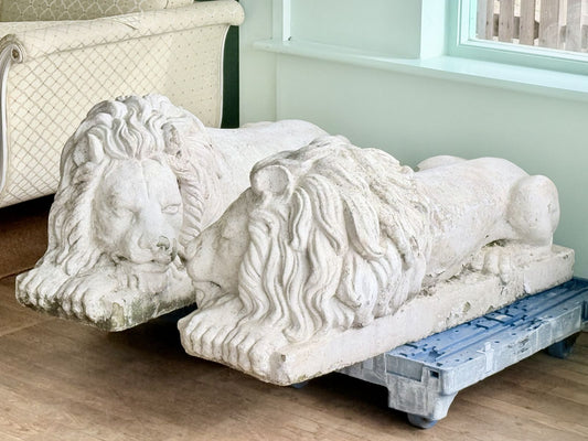 Pair of cast stone Canova lions side by side on dollies