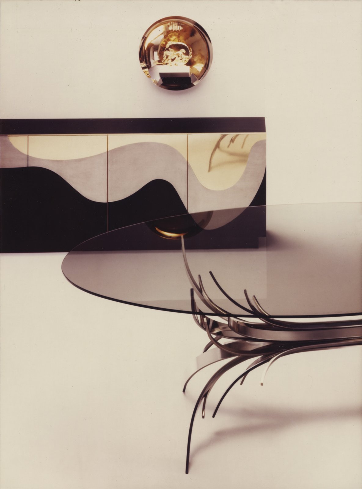 Vintage Maria Pergay advertisement with a Gerbe table and wall cabinet
