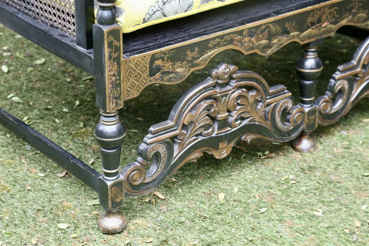 Close-up of carved lacquered stretcher and bun feet