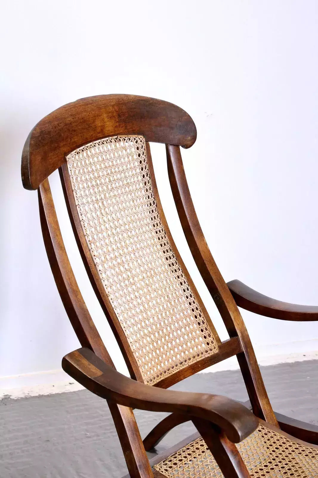 Close-up of caned back and walnut frame, steamer chair