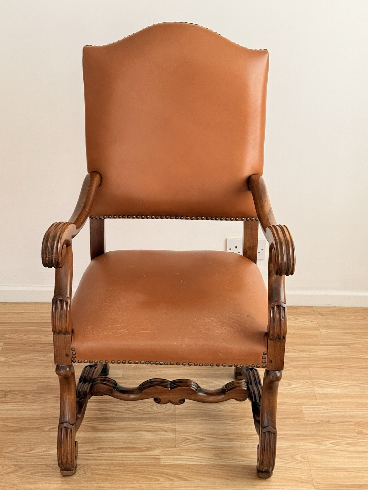 Spanish carved wood armchair, front view of seat and stretcher