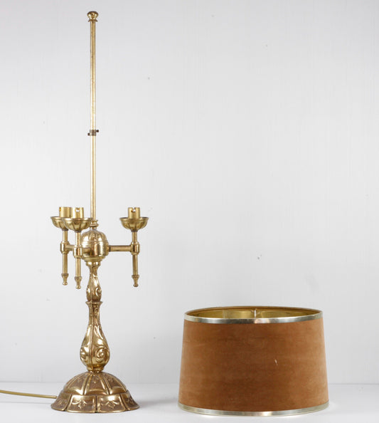 Vintage French Art Nouveau brass bouillotte lamp with shade set beside the base