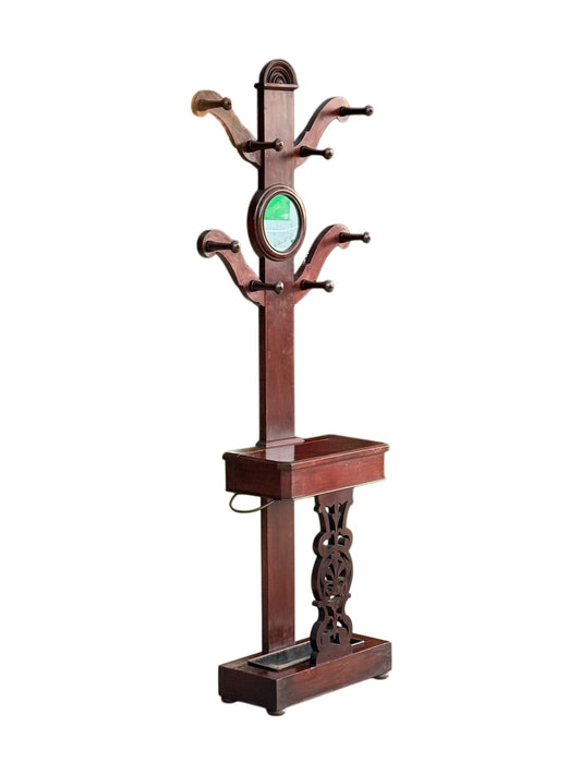 Victorian mahogany hall stand coat tree, front view showing the circular mirror and eight turned pegs
