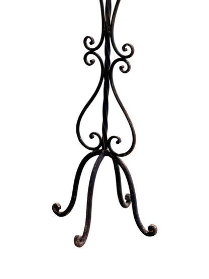 Wrought iron candelabra, close-up of scrolled tripod base and feet