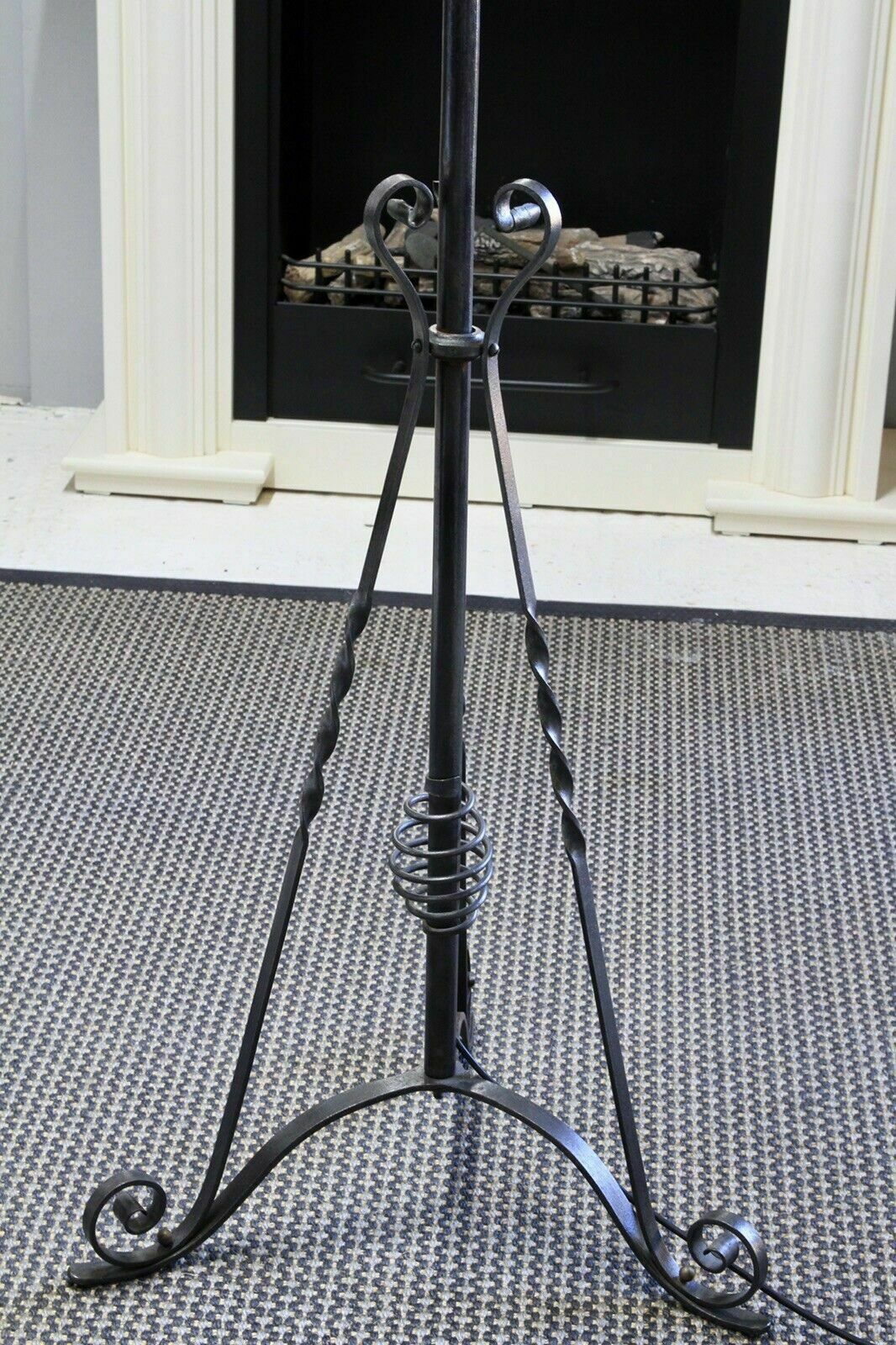 Wrought iron rise and fall lamp, close-up of twisted legs and scrolled tripod feet