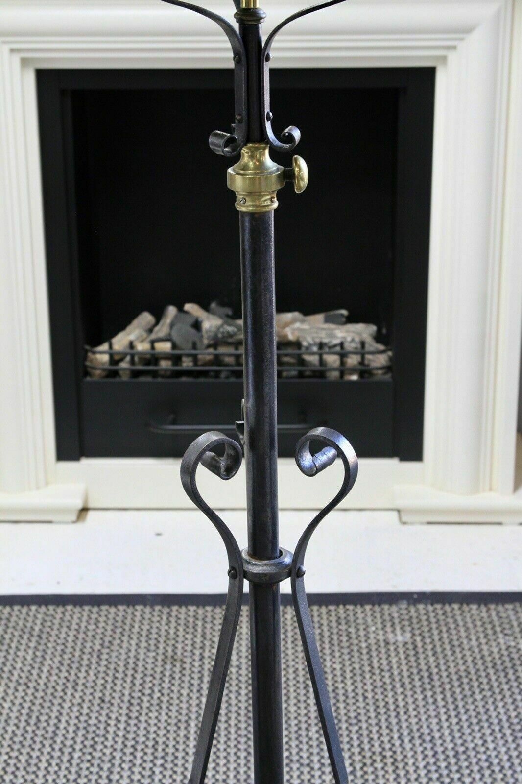 Wrought iron standard lamp, detail of heart-shaped scrolls and brass collar