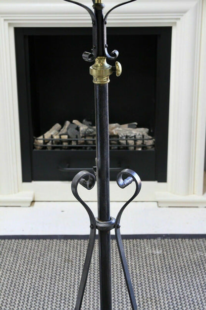 Wrought iron standard lamp, detail of heart-shaped scrolls and brass collar