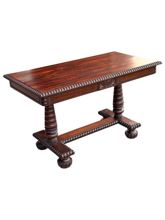 Anglo-Indian solid rosewood library centre table, three-quarter view with gadrooned edge, turned columns and bun feet