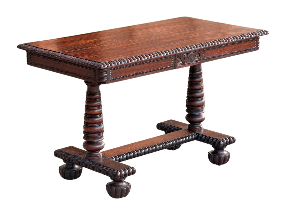 Anglo-Indian rosewood library centre table, front three-quarter view showing the pearl-beaded frieze and gadrooned stretcher