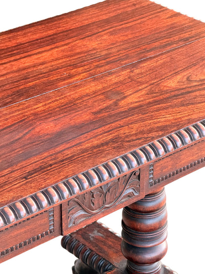 Close-up of the figured rosewood top with the board joint, gadrooned edge and carved foliate lotus panel