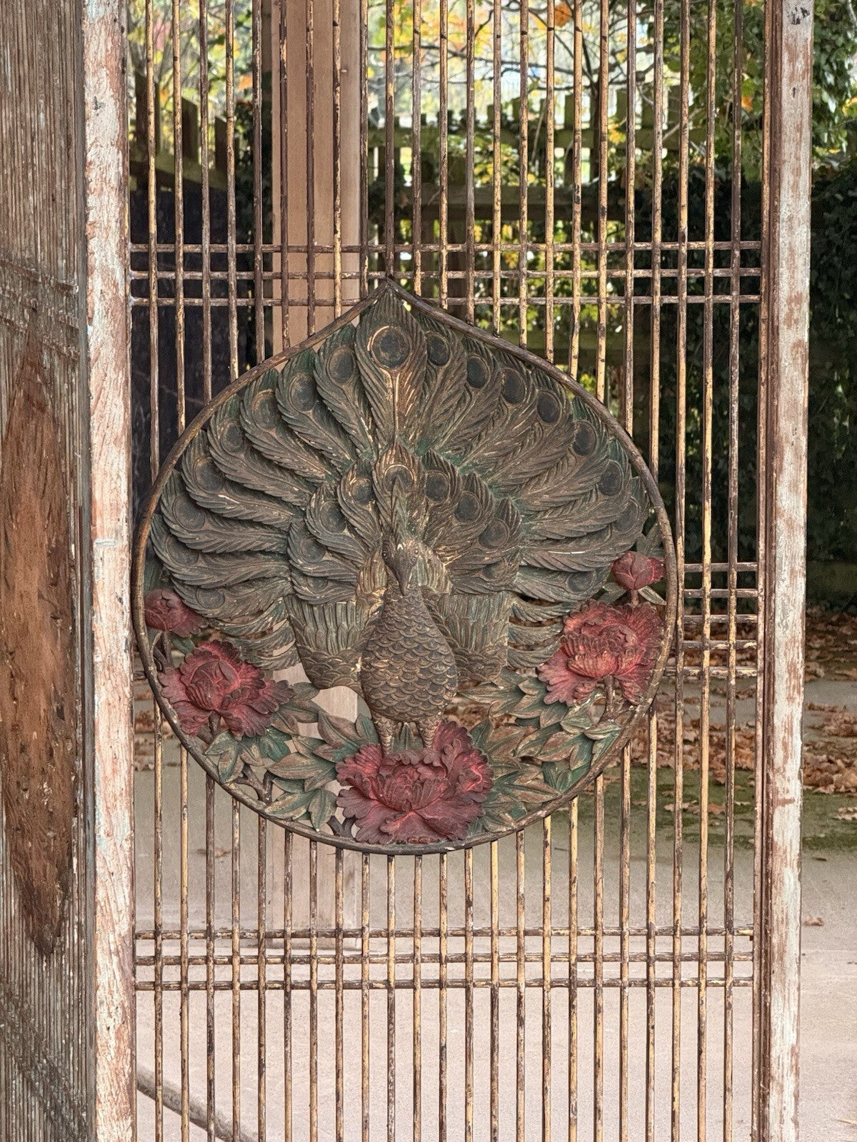 Carved peacock and red peony medallion, angled view