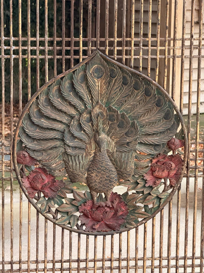 Close-up of carved peacock medallion with red painted peonies and gilt highlights