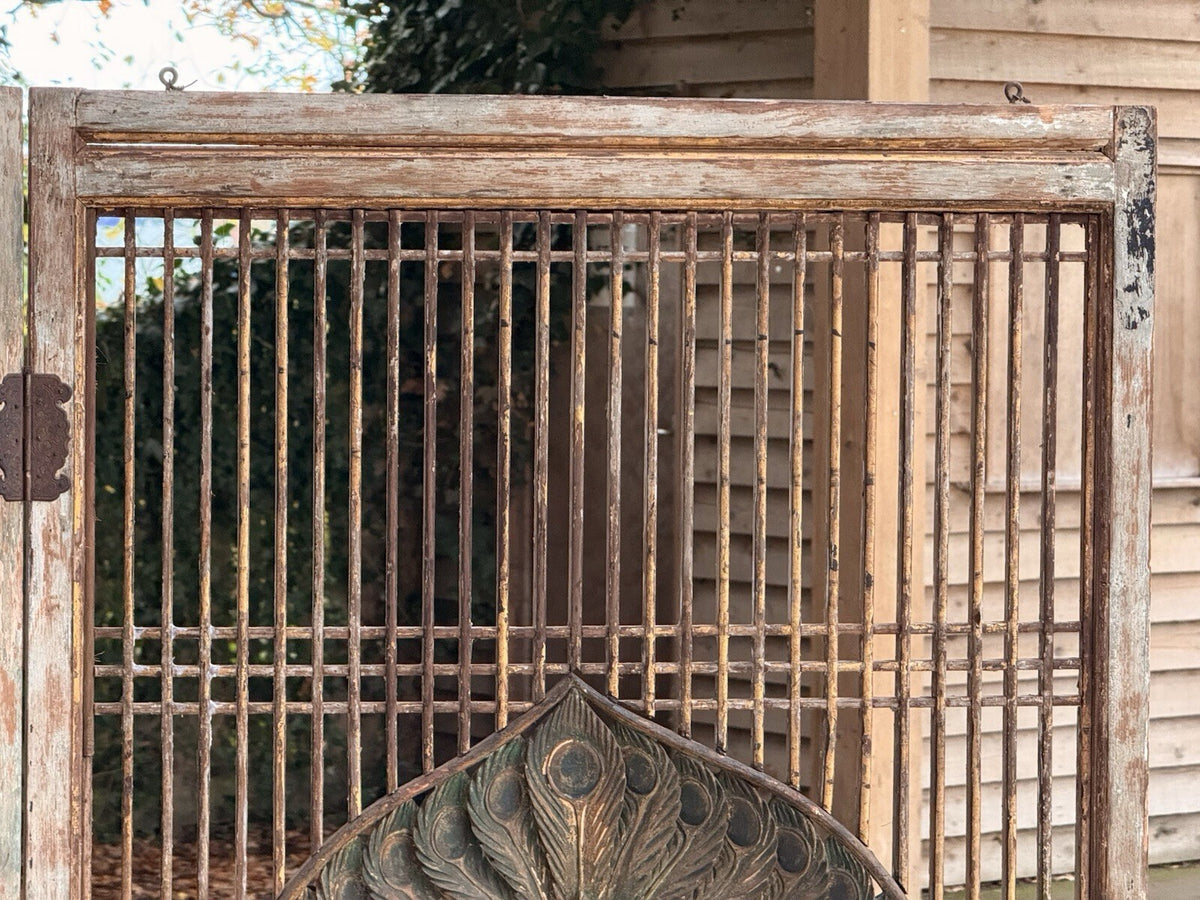 Close-up of slatted lattice and top of carved peacock medallion