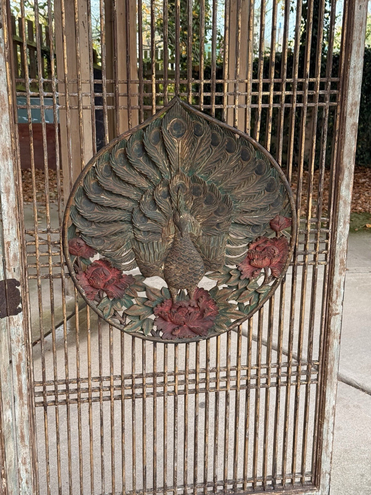Close-up of gilded peacock and red peonies, carved screen medallion
