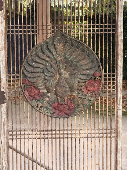 Carved peacock medallion with floral border on wooden lattice