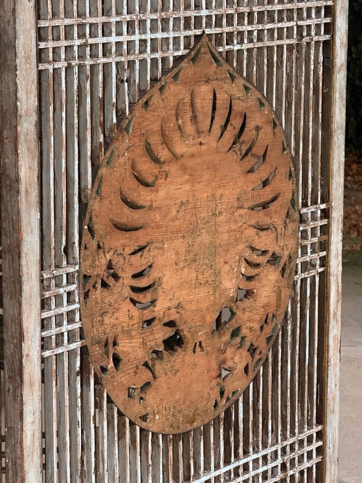 Back of the peacock medallion showing natural carved wood
