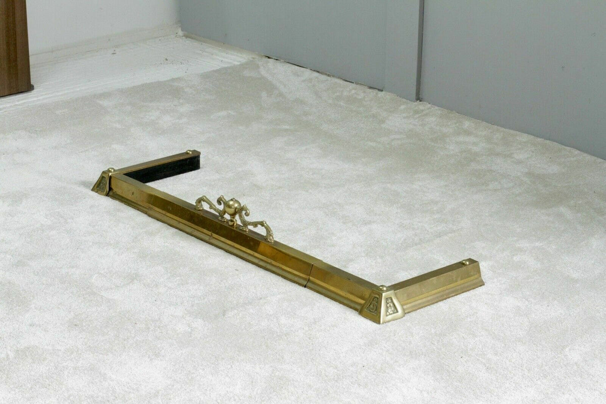 French antique brass fireplace fender, angled view on carpet