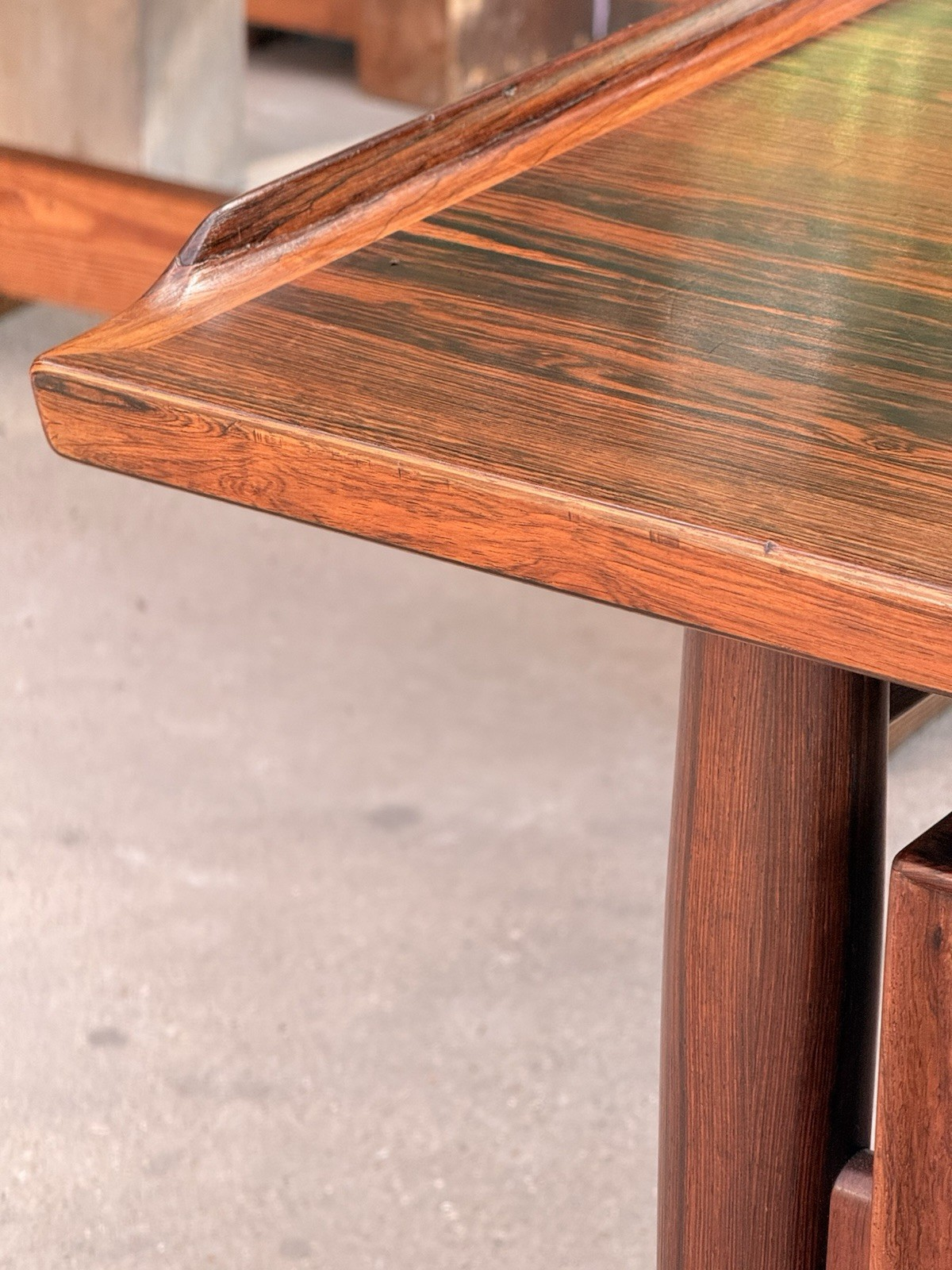 Close-up of raised sculpted edge on the rosewood desk top