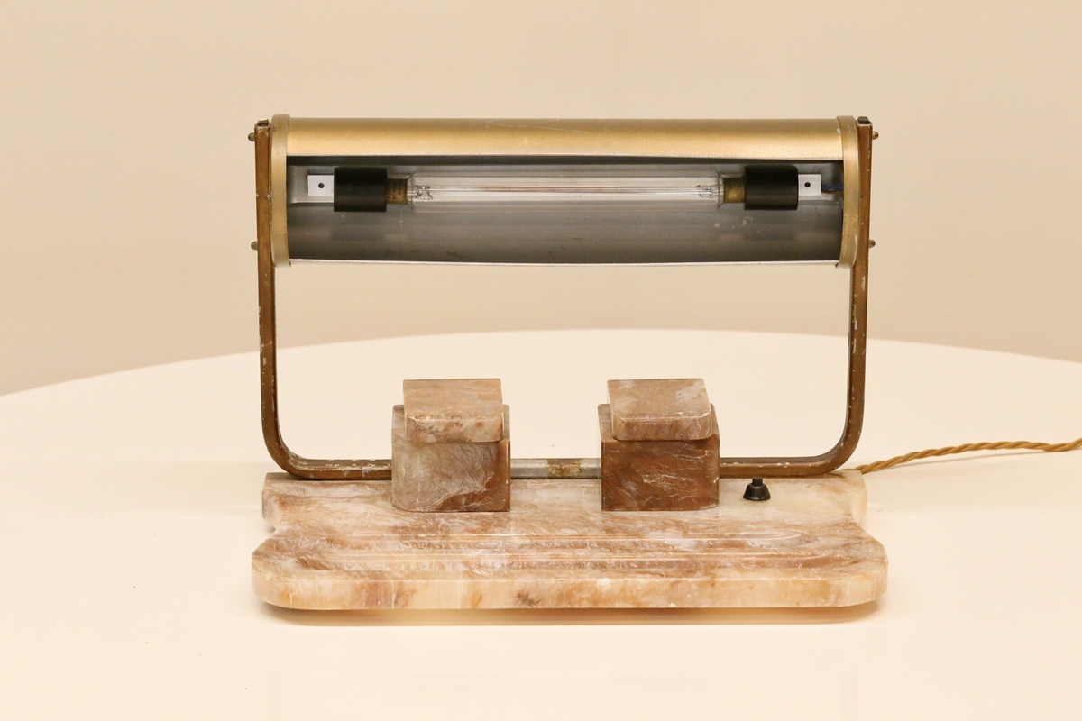 Art Deco desk lamp, front view showing fluorescent tube in brass shade