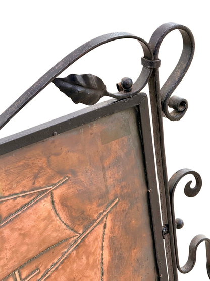 Close-up of wrought iron scroll and leaf top corner on the copper fire screen