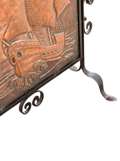 Close-up of repoussé copper galleon hull and waves, Newlyn fire screen