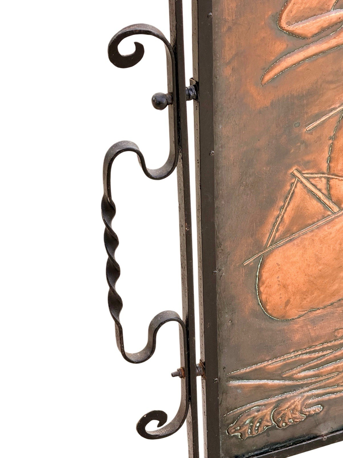 Close-up of twisted wrought iron side bar and copper panel edge