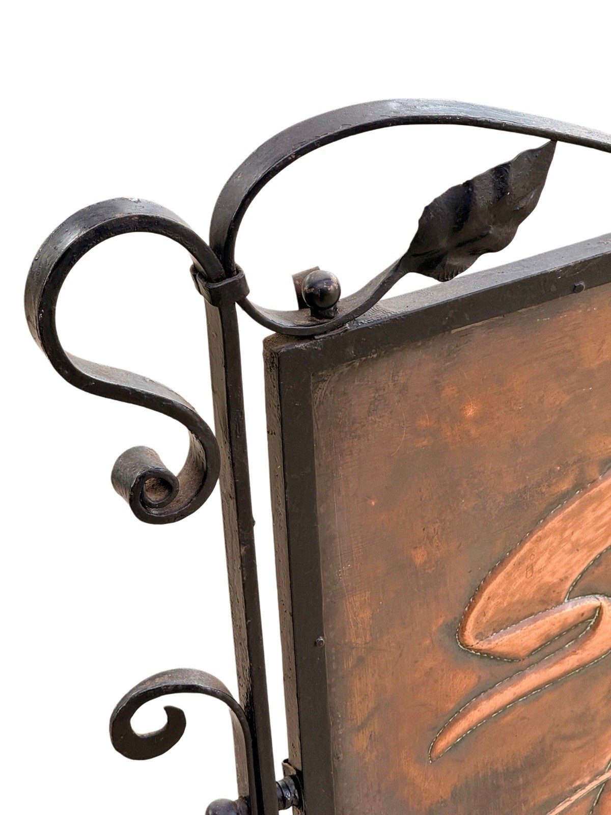 Close-up of scrolled wrought iron frame and leaf finial, Arts & Crafts fire screen