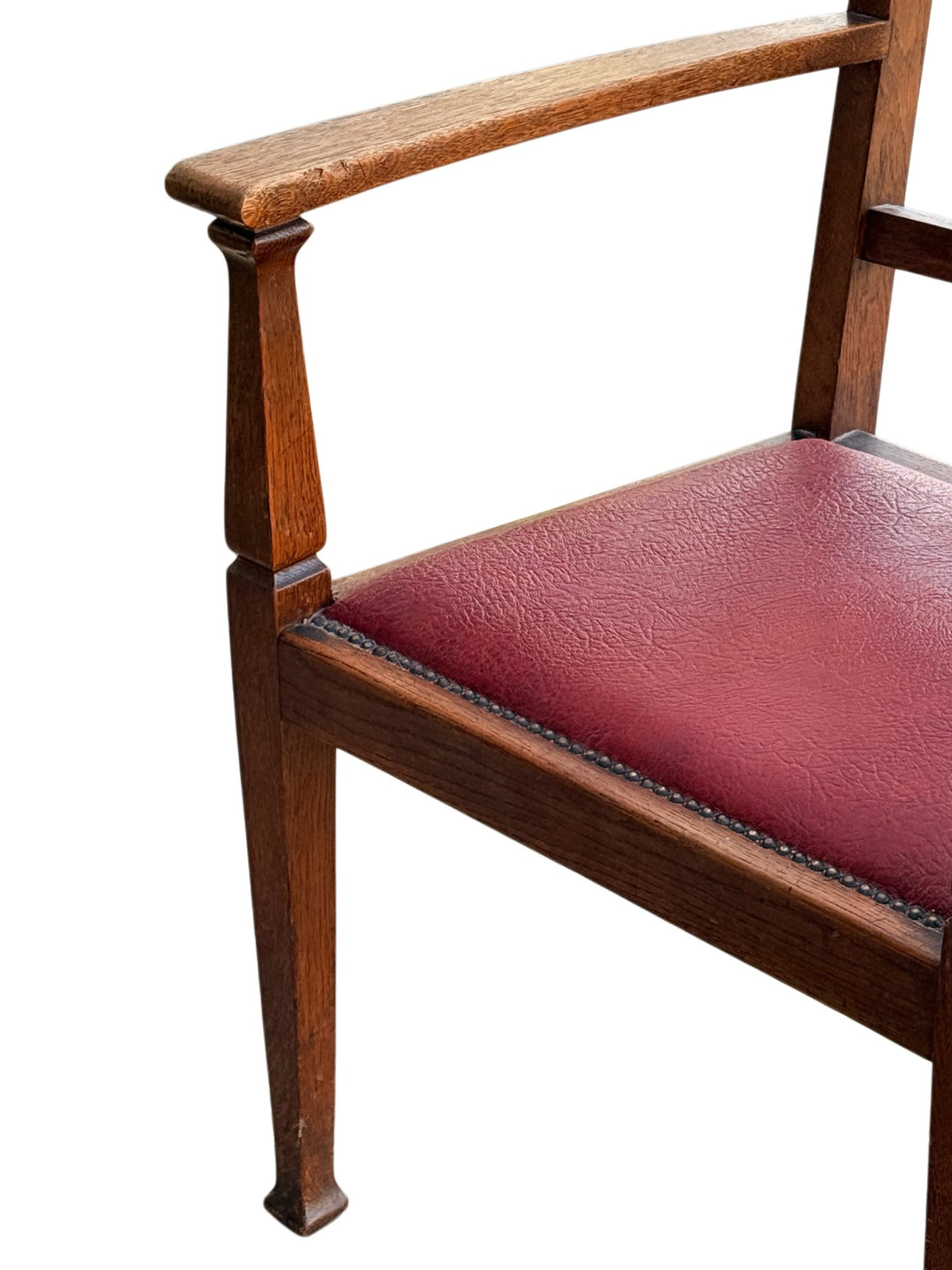 Detail of the flat shaped oak arm on its collared square support above the red leatherette seat