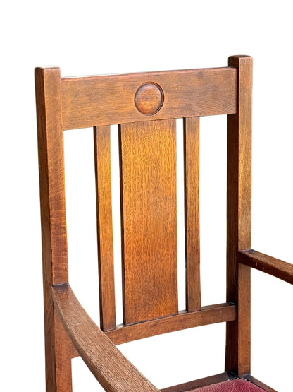Detail of the oak chair back: recessed roundel in the top rail above three upright splats with figured grain