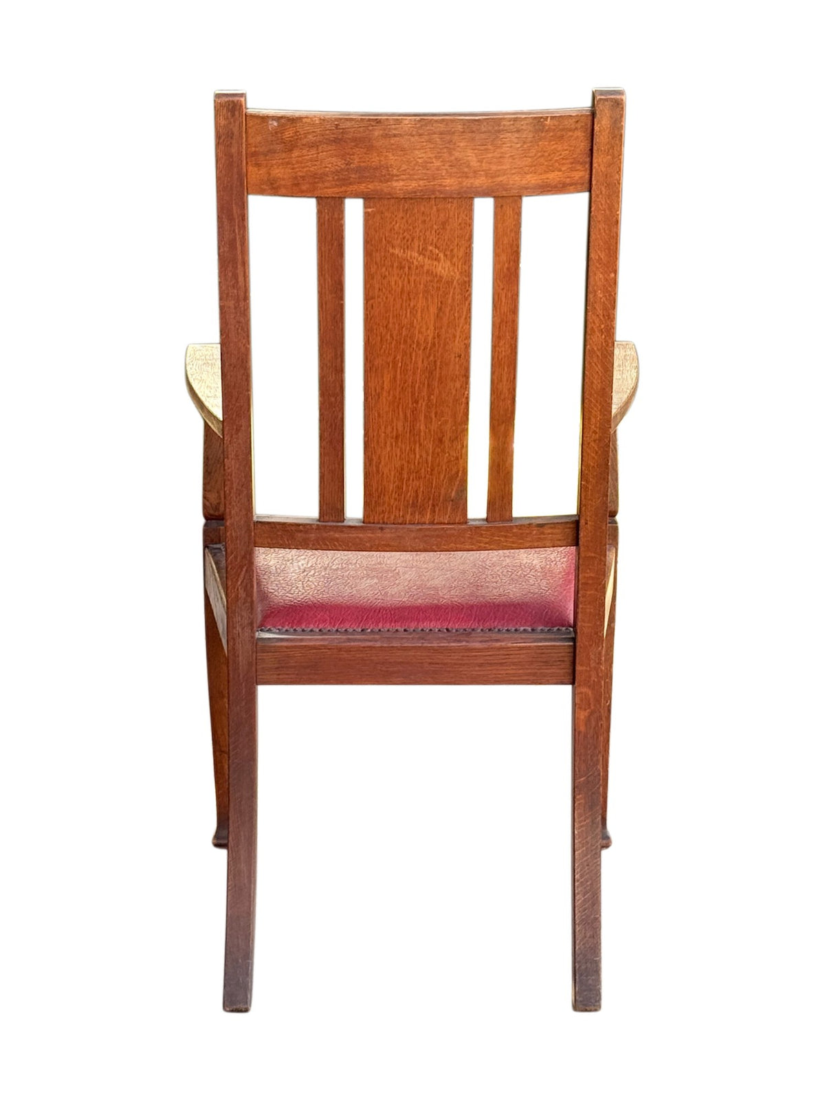 Rear view of the Arts & Crafts oak armchair showing the back splats and splayed back legs