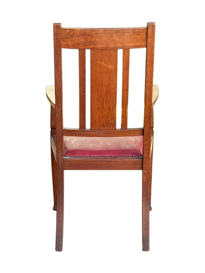Rear view of the Arts & Crafts oak armchair showing the back splats and splayed back legs