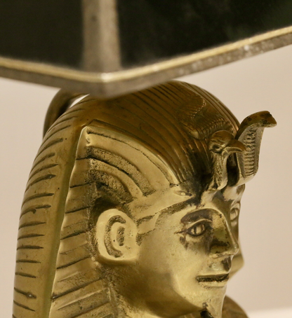 Close-up of pharaoh face and headdress detail under the shade