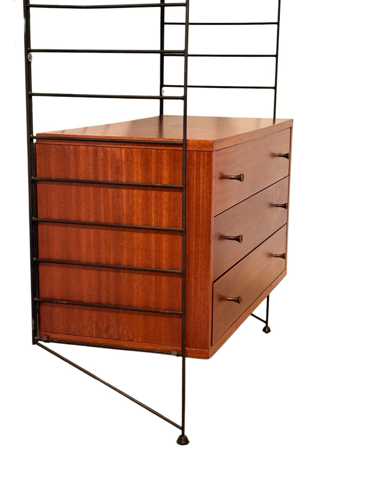 Close-up of the Brianco teak drawer chest between black metal ladders