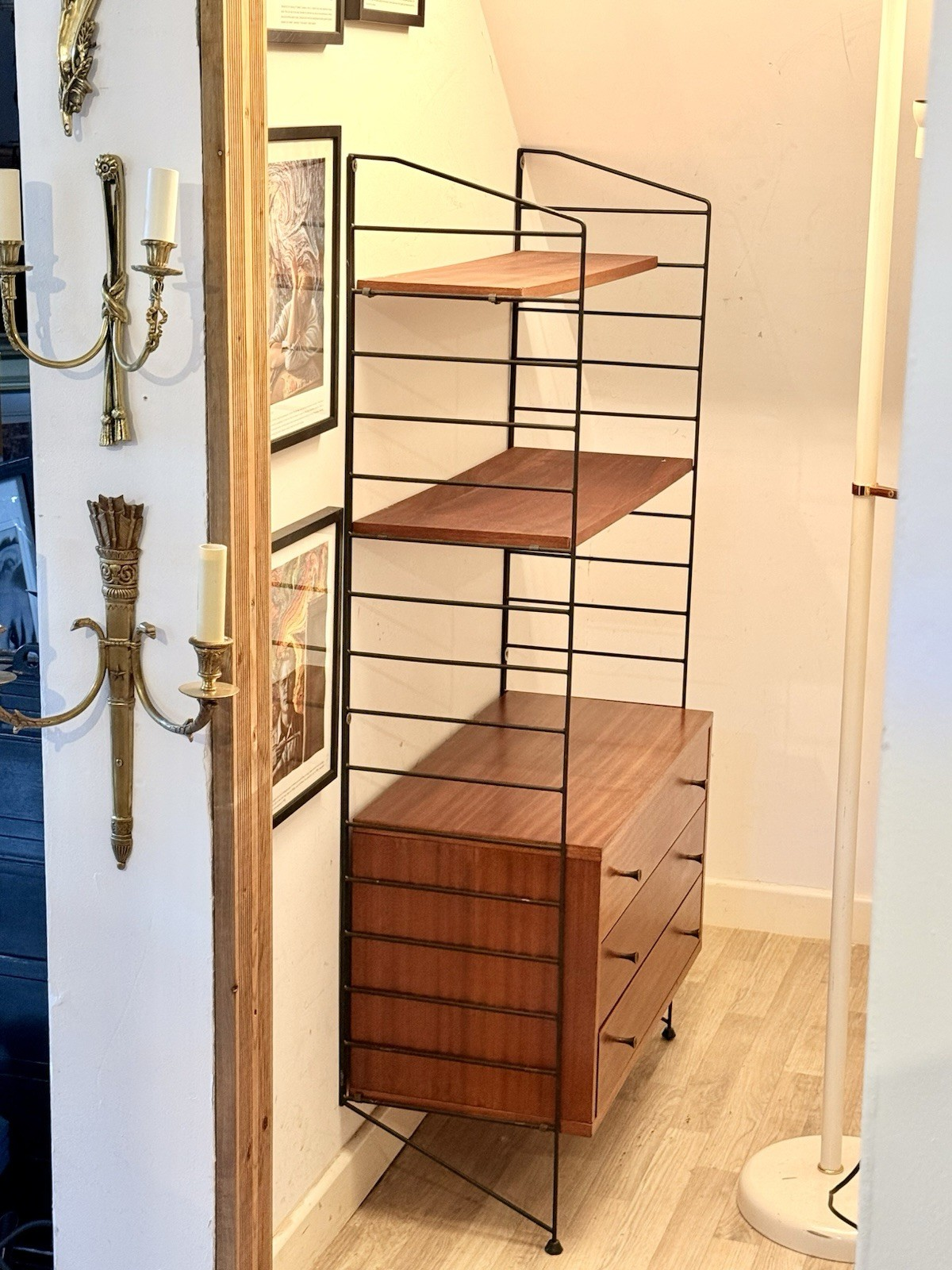 Brianco teak and metal ladder shelving wall unit in a room setting