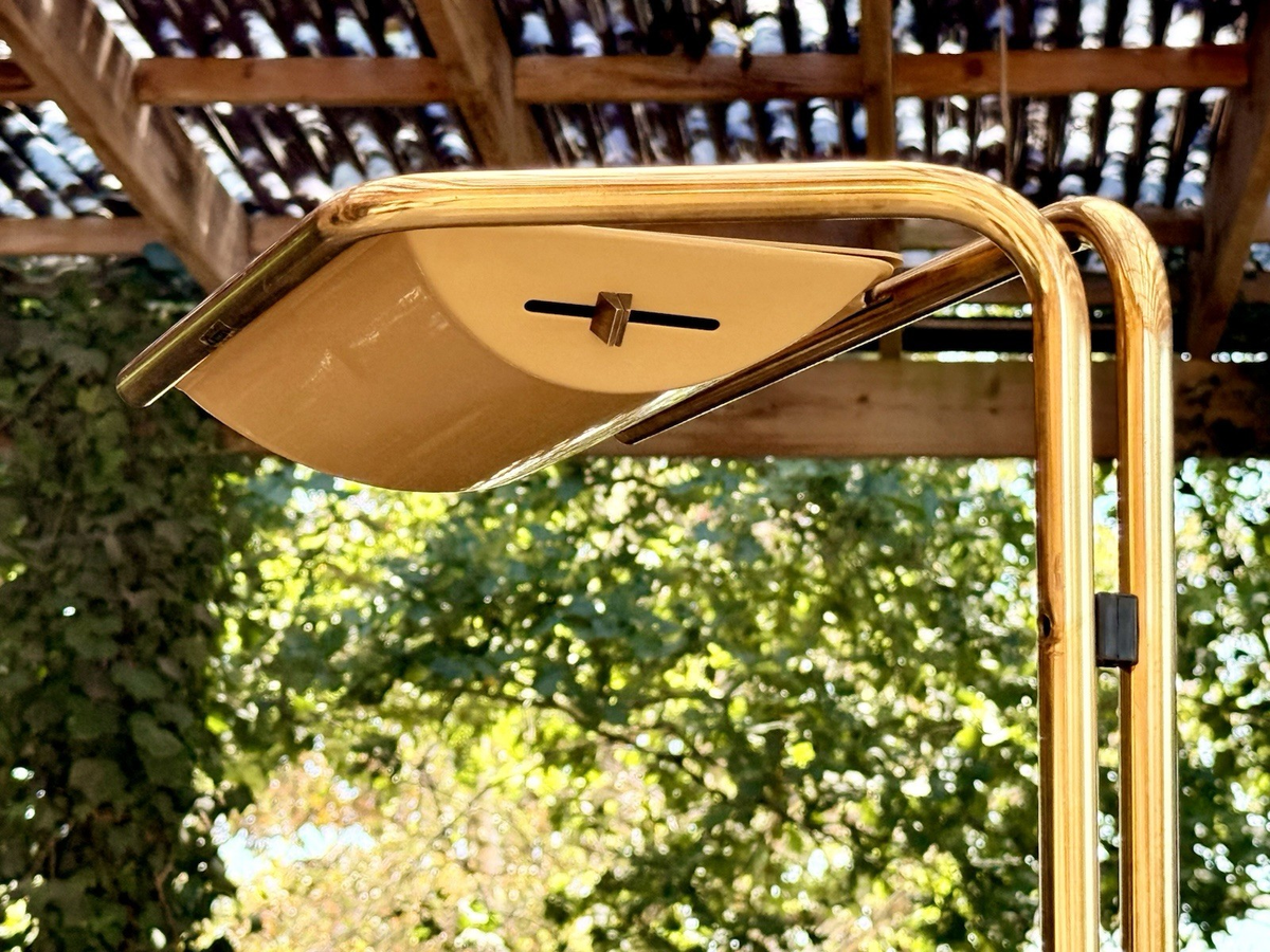 Close-up of the curved brass arm and cream shade, Gecchelin lamp