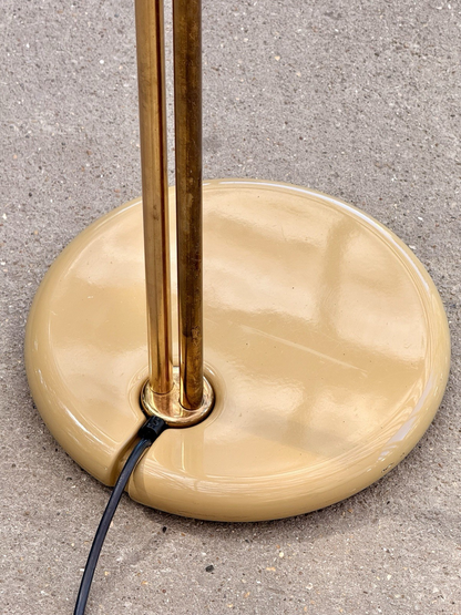 Close-up of cream enamel base with twin brass stems, iGuzzini lamp
