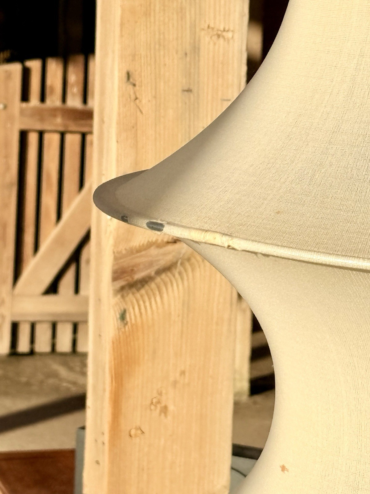 Close-up of white stretch fabric and metal ring, Falkland lamp