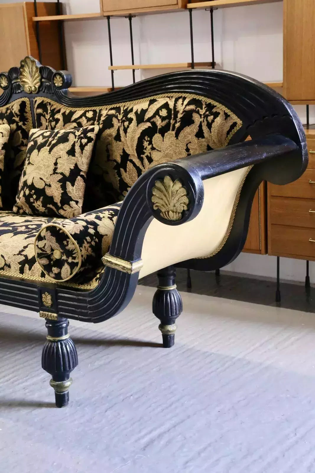 Empire Regency ebonised double-ended couch, end view in a room setting