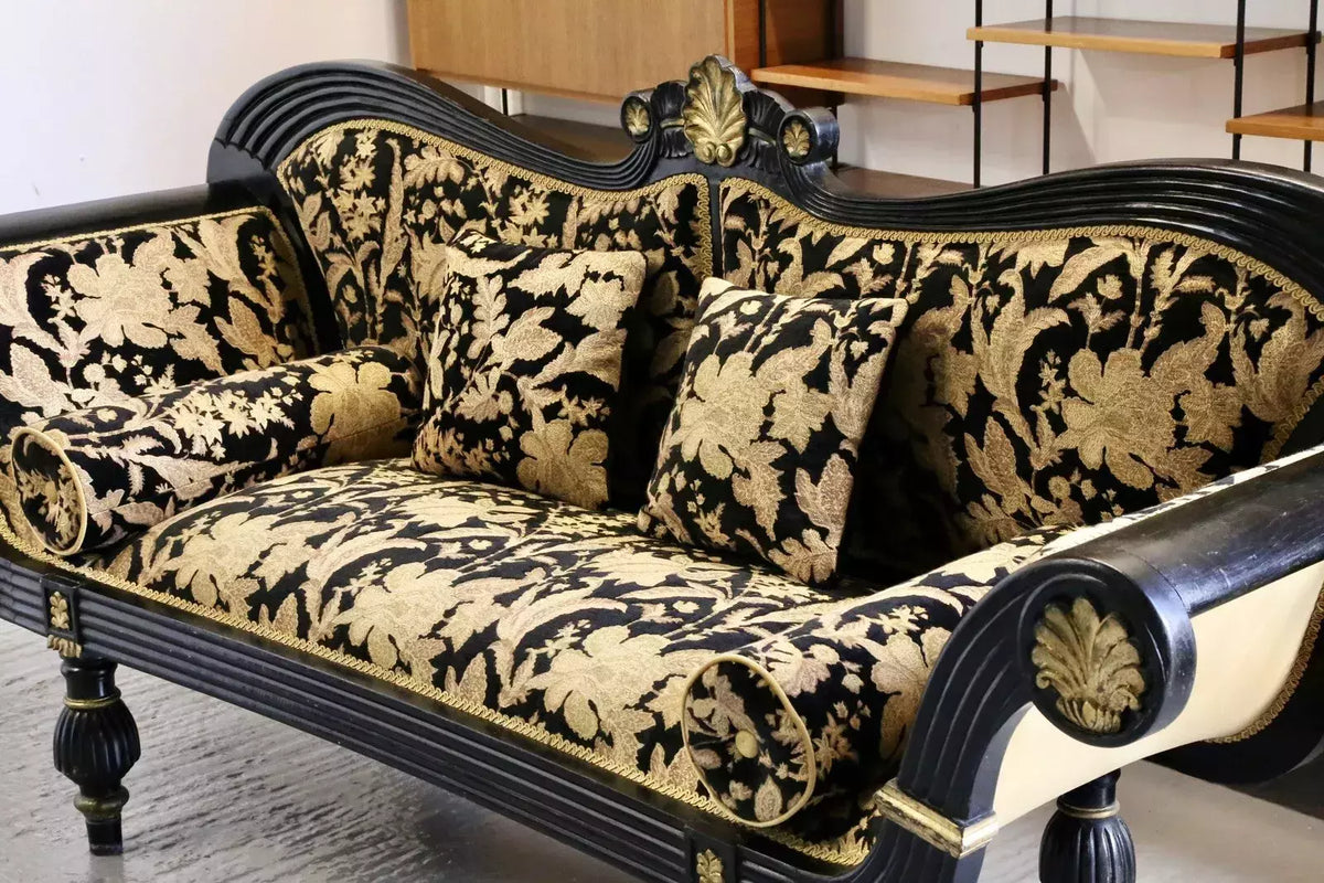 Close-up of black and gold damask cushions on the Regency couch