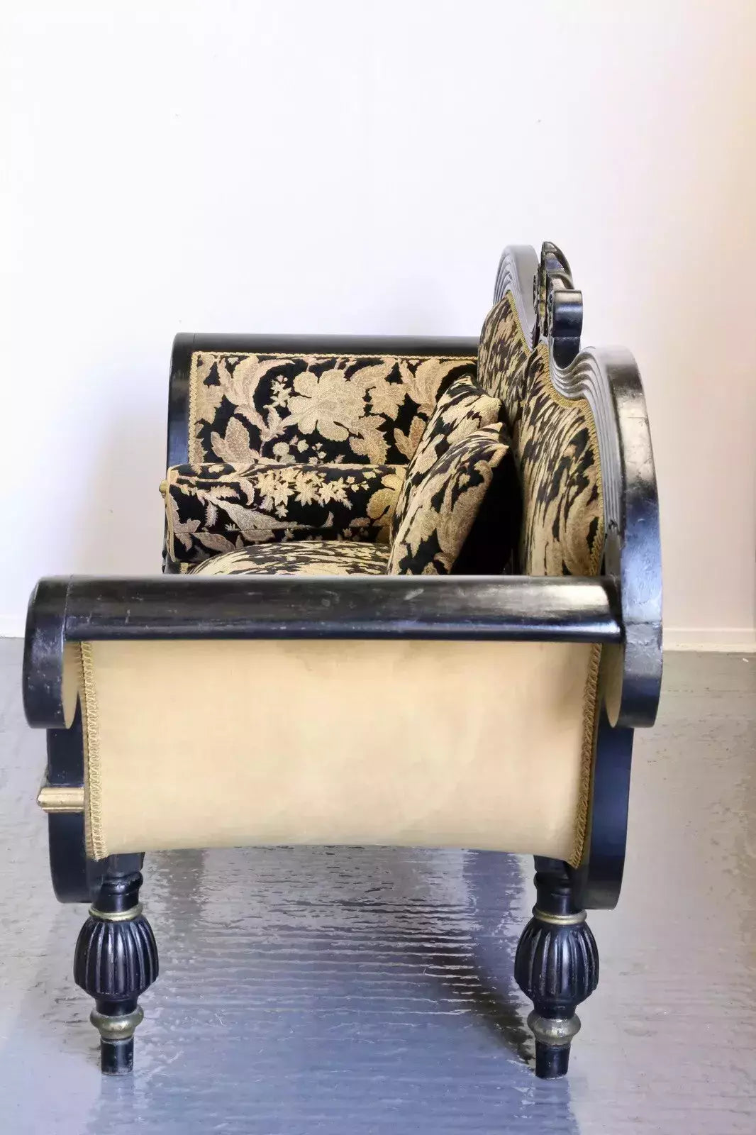 Side view of the Regency ebonised couch showing upholstered end