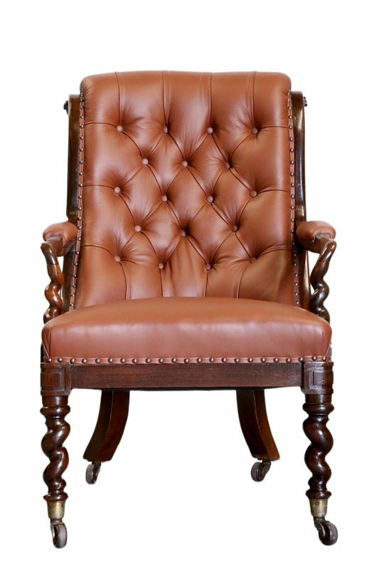 Antique William IV rosewood armchair with barley twist legs, scrolled arms and button-back tan leather with brass studs