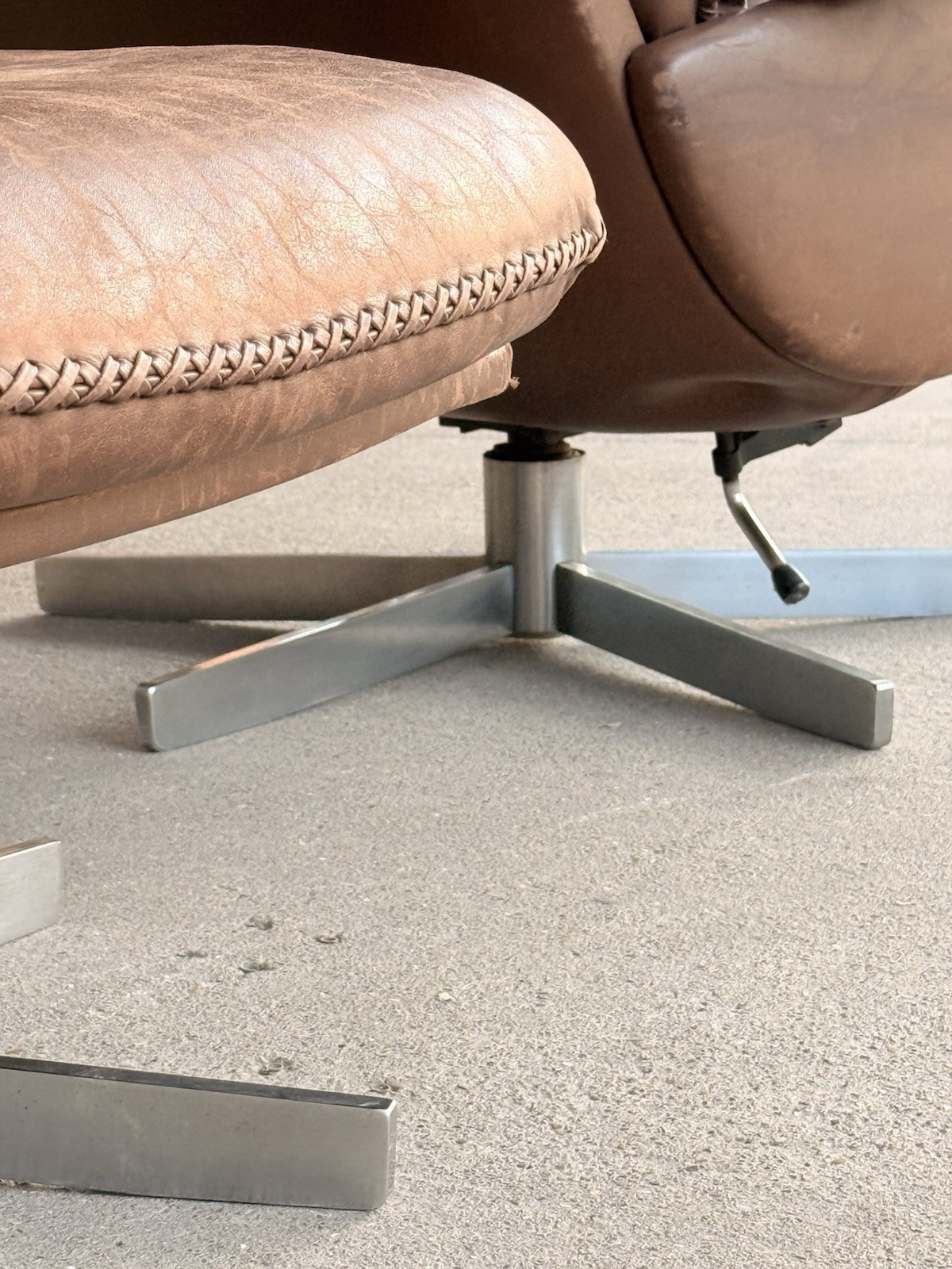 Close-up of swivel star base and stitched ottoman edge