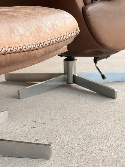 Close-up of swivel star base and stitched ottoman edge