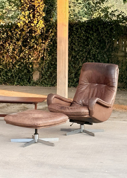 De Sede S231 brown leather lounge chair and ottoman in a garden setting