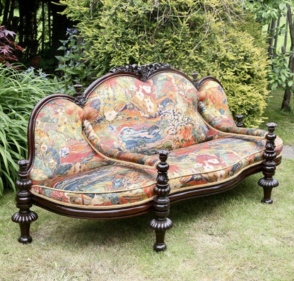 Fine Victorian carved rosewood conversation seat upholstered in colourful Osborne & Little fabric, turned legs