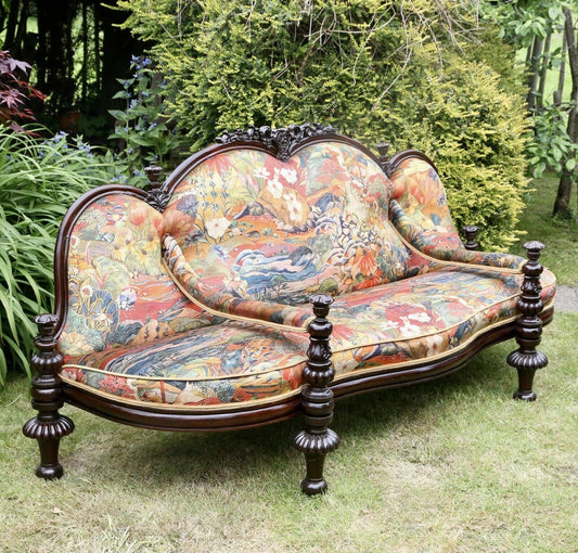 Fine Victorian carved rosewood conversation seat upholstered in colourful Osborne & Little fabric, turned legs