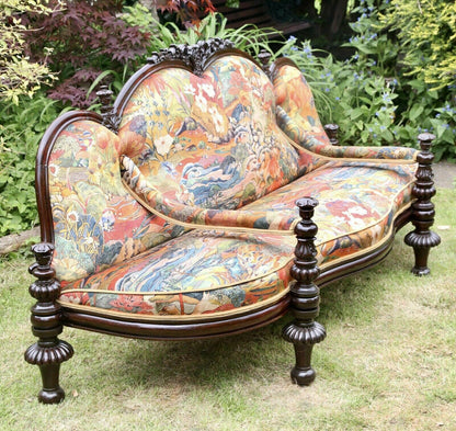 Victorian rosewood conversation seat, three-quarter view showing turned legs